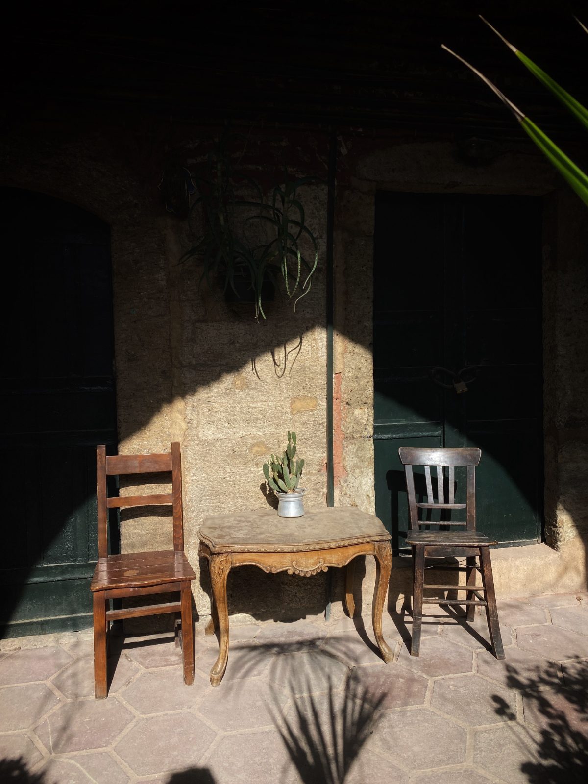 Two chairs facing each other in a quiet courtyard