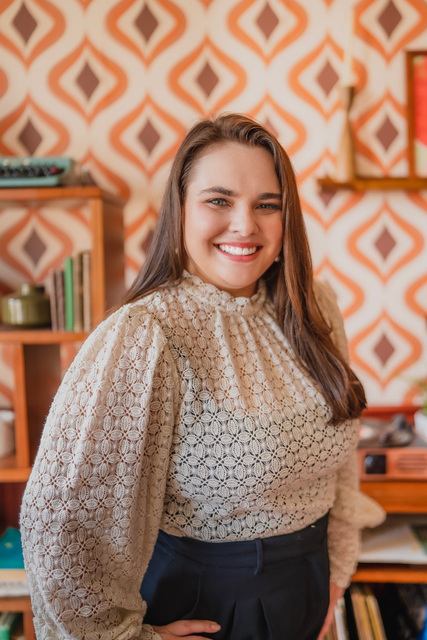 Andrea Lynn Piazza smiling in a cream lace blouse